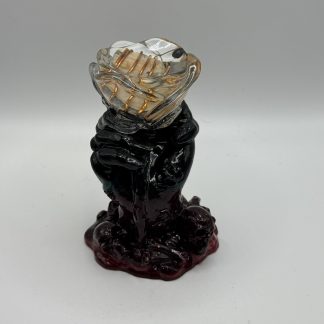 Hand holding a rose orgonite